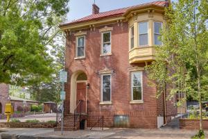 an old red brick house on a street at Darling Pennsylvania Vacation Rental with Porch! in Pottstown