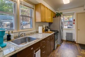 a kitchen with a sink and a refrigerator at Darling Pennsylvania Vacation Rental with Porch! in Pottstown