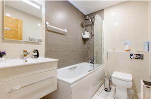 a bathroom with a sink and a toilet and a bath tub at Charlotte Double Room in London +18 photos