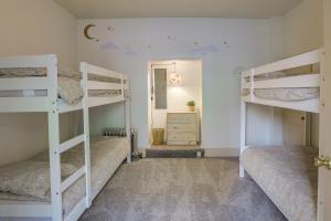 a room with three bunk beds and a mirror at Darling Pennsylvania Vacation Rental with Porch! in Pottstown