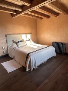 a bedroom with a large bed in a room at Le Hameau in Figari
