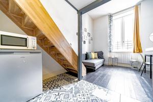 a living room with a staircase and a couch at Studio Dumas-Charmant 2 pers-métro Valmy in Lyon