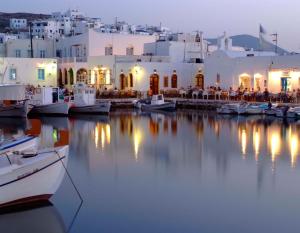 a group of boats in a harbor with buildings at HOUSE 3Bedroom Maisonette ΕΞΟΧΙΚΟ Alyki PAROS 50m from BEACH ideal for families in Aliki