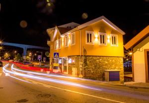 a long exposure photo of a street at night at A Tendinha - Guest House in Peso da Régua