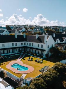an aerial view of a building with a swimming pool at The Farmhouse Hotel in Langebaan
