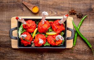 a pan filled with food on a wooden table at PARK SIGNATURE HOTELS - Royal Benza in Vijayawāda