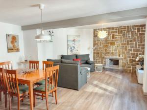 a living room with a couch and a table and a fireplace at Casa Mariñeira in Sanxenxo