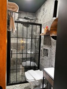 a bathroom with a toilet and a shower with a window at Sunset Boutique Hotel Marmaris in Marmaris