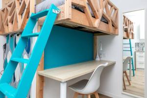 a room with a desk and a loft bed at Le Rêve Bleu in Brest