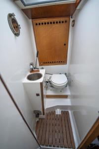 a small bathroom with a toilet and a sink at Cyclades sailing Experience in Finikas