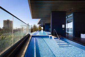 a swimming pool on the side of a building at ULTIQA Signature at Broadbeach in Gold Coast