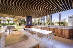 a restaurant with a table and chairs on a balcony at ULTIQA Signature at Broadbeach in Gold Coast