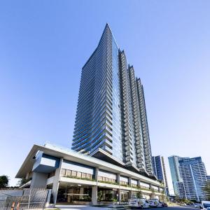 a tall building with cars parked in front of it at ULTIQA Signature at Broadbeach in Gold Coast
