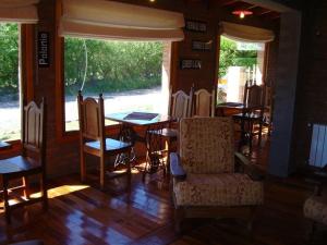 a dining room with tables and chairs and a window at Hosteria Miyazato Inn in El Calafate