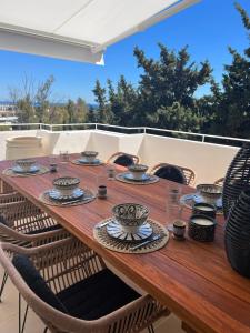 a wooden table with bowls and plates on it at Apartment in Marbella Golden Mile in Marbella