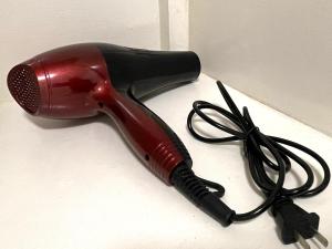 a hair dryer with a cord on a counter at Althea's Cozy Apartment in Manila