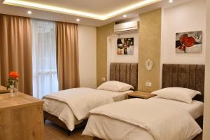 Postel nebo postele na pokoji v ubytování Elite Hotel