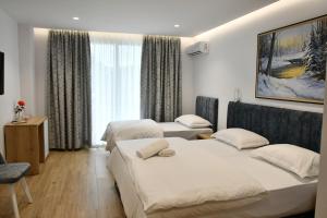 Postel nebo postele na pokoji v ubytování Elite Hotel