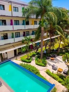 an aerial view of a hotel with a pool and palm trees at ONOMO Hotel Bamako in Bamako