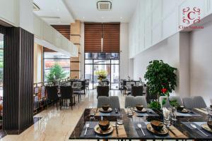 a dining room with tables and chairs in a restaurant at Ciao Saigon 2 Hotel in Ho Chi Minh City