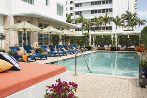 
a patio area with chairs, tables and umbrellas at Circa 39 Hotel Miami Beach in Miami Beach
