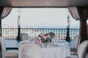 a table with a white table cloth and flowers on it at Grand Hotel Parker's in Naples