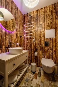 a bathroom with a sink and a toilet at Arthouse Narnia in Liepāja