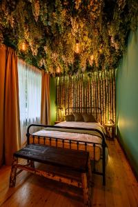 a bedroom with a bed with flowers on the ceiling at Arthouse Narnia in Liepāja