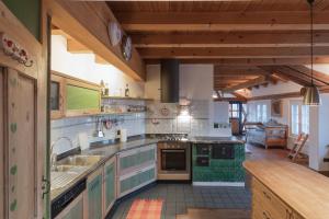 a kitchen with a sink and a stove top oven at Casa del Noce in Fiera di Primiero