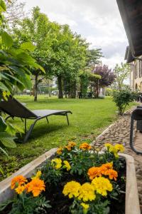 a garden with flowers and a bench in a park at VILLA BOTTERA - Jacuzzi & Private Garden in Riforano