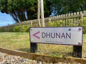 a sign that says dunstan in front of a fence at Raven's Gully - Brodick, Isle Of Arran in Brodick