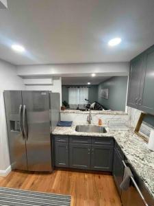 a kitchen with a stainless steel refrigerator and a sink at Beautiful 1 bedroom In the heart of Albany in Albany
