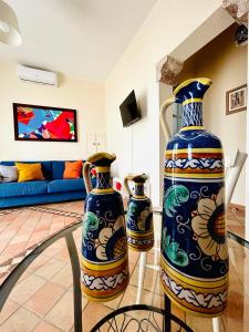 two vases sitting on a glass table in a living room at Casa Amelia - Charme in Taormina in Taormina
