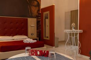 a bedroom with a bed and a table in a room at Exclusive in Palermo