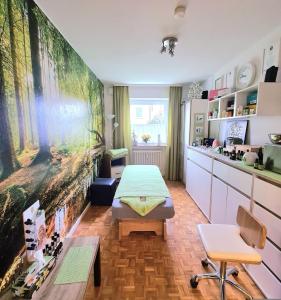 a room with a table and a large painting on the wall at Ferienwohnung Waldengel in Bad Abbach