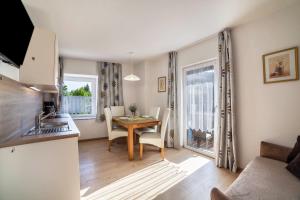 a kitchen and a dining room with a table and chairs at Residence Alpina Comfort Nr 1 in Tesimo
