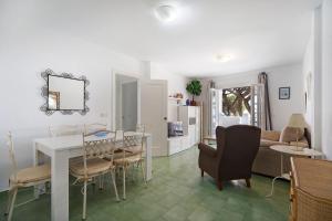 a kitchen and living room with a table and chairs at Apartamento primera línea in Chiclana de la Frontera