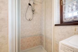 a shower with a glass door in a bathroom at Residence San Zeno S P House in Bardolino +13 photos