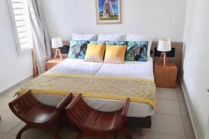 Кровать или кровати в номере Appartement St François Manganao Guadeloupe