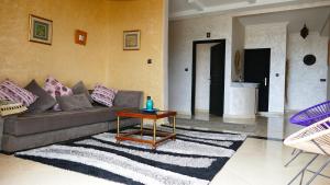 a living room with a couch and a table at Villa shahinaz in Essaouira city in Essaouira