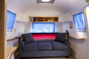 a living room with a couch in a caravan at Cowabunga By Pacific Blue in Fort Bragg