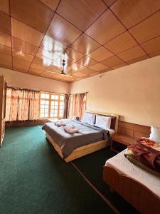 a large bedroom with two beds in a room at Zambala guest house in Leh