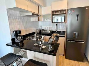 a kitchen with a black counter and a refrigerator at Luxury Apartment in Magdalena 2BR limit San Isidro in Lima