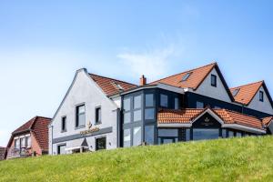 a house on top of a hill at Nordseehotel Tausendschön in Carolinensiel