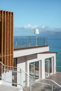 a balcony of a house with a view of the ocean at Hotel Belvedere Resort in Castellammare del Golfo