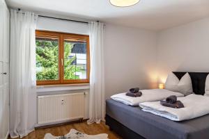 a bedroom with a bed with two teddy bears on it at Alpblick Apartment Alpspitze in Garmisch-Partenkirchen