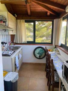 Una cocina con encimera y mesa con sillas. en Una Finestra sul Mare, en Augusta