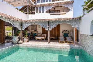 a house with a swimming pool and a patio at lory‘s home in Bangkok