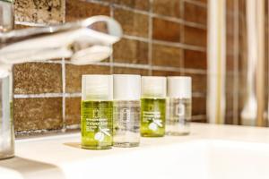 three bottles of essential oils sitting on a bathroom counter at Apartments Alba in El Médano