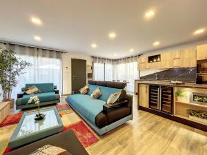 a living room with a couch and a table at Les villas du Golf Mougins in Mougins
